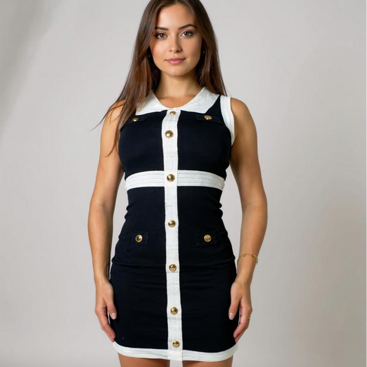 Elegantes Damenkleid in Schwarz-Weiss mit goldenen Knopfdetails und Kragen – figurbetontes, ärmelloses Dress im edlen Chic. Perfekt für Business-Events, Dinner oder elegante Alltags-Looks. Jetzt bei CasinoFashion in Winterthur entdecken.